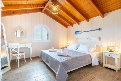 a bedroom with a bed and a desk at Villa Konstantina Lulas Penthouse in Petrití