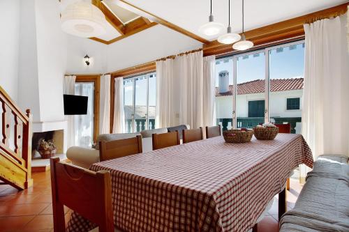 a dining room table with a checkered table cloth at A Casa da Concha in São Pedro de Moel