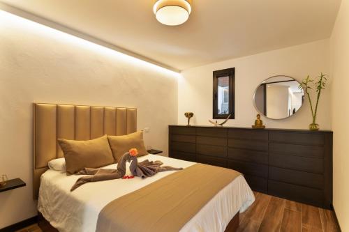 a bedroom with a large bed with a mirror at Rincón de la Fontana in San Nicolás