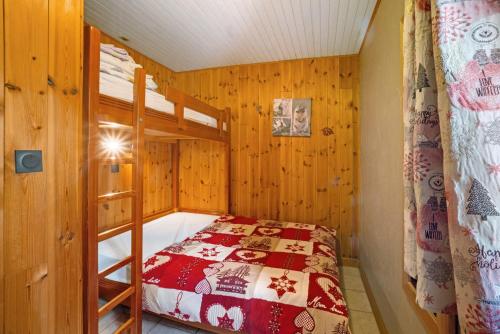 a bedroom with a bed and a bunk bed at Chez Stephane et Estelle in Villarodin-Bourget