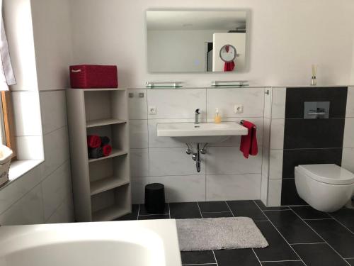 a white bathroom with a sink and a toilet at Haus Peschl Fewo 2 in Neureichenau
