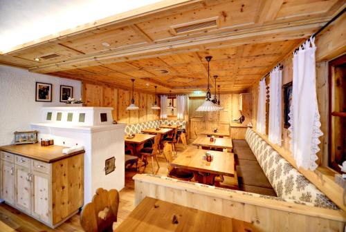 a large room with wooden tables and benches at Hotel Arnika in Ischgl