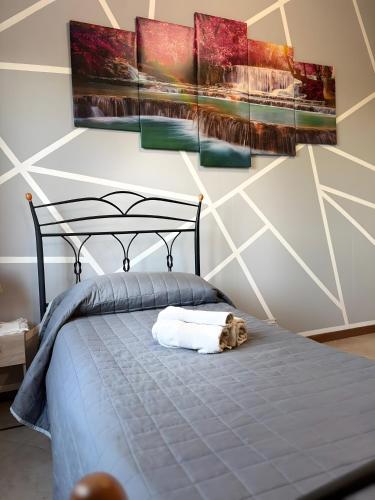 a dog laying on a bed in a bedroom at Casa Domus Oppiorum in Ca degli Oppi