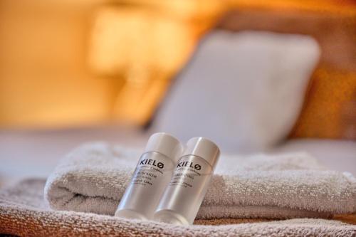 two bottles of nikita products sitting on a towel at L'Ecrin de Venosc piscine privée in Les Deux Alpes
