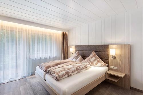 a bedroom with a large bed and a window at Landhaus Kramer Meine Cardplus inkl in Willingen