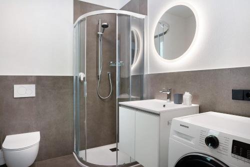 a bathroom with a shower and a toilet and a sink at Haus Weinblick Apt 5 in Magrè allʼ Adige