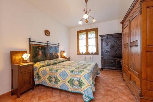 a bedroom with a bed and a dresser in it at La Sassetta in Bibbona