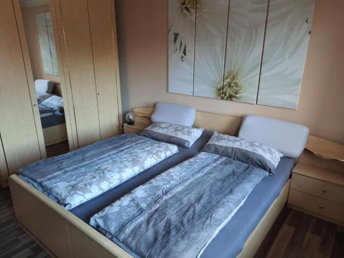 a bedroom with a bed with blue comforter at Ferienwohnung Börner in Frauenstein
