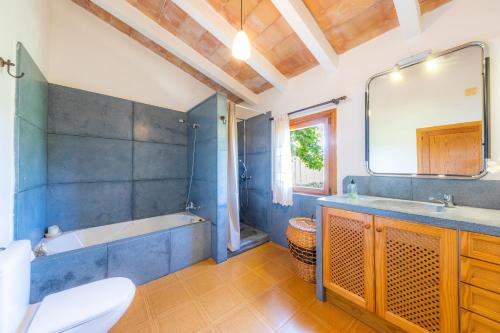 a bathroom with a tub and a sink and a toilet at Can Sua in Artá