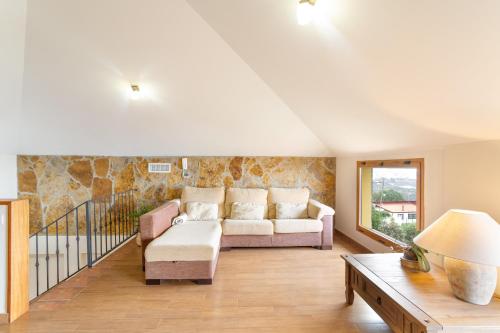a living room with a couch and a table at Casa Yaraina in Firgas