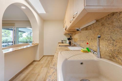 a kitchen with a sink and a counter at Oasis Salou Pool Beach and Bbq in Salou