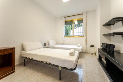 a hospital room with two beds and a window at Oasis Salou Pool Beach and Bbq in Salou