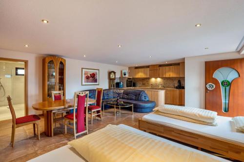 a living room with two beds and a kitchen at Haus am Bächel 2 in Obersasbach