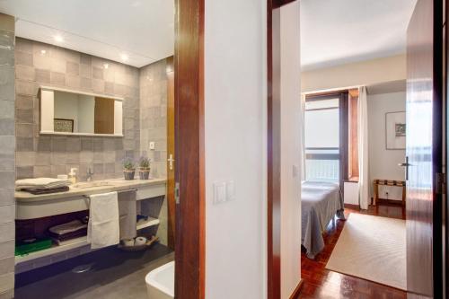 a bathroom with a sink and a bed at Vista Formosa in Funchal