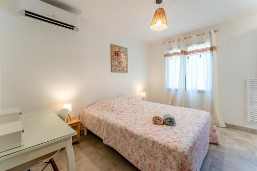 a bedroom with a bed with two shoes on it at Bergeries Saumane, Les Lavandes in Saumane-de-Vaucluse