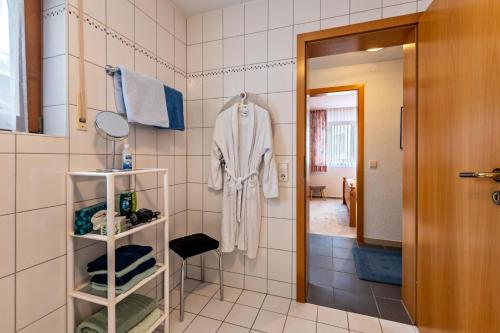 a bathroom with a robe hanging on a wall at Ferienwohnung Matt in Todtmoos