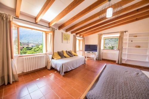 a bedroom with a bed and a large window at Villa Rae in Sóller