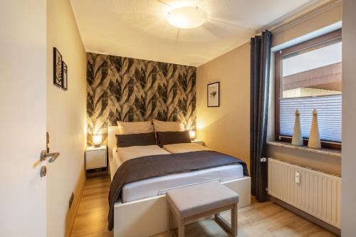 a bedroom with a large bed and a window at Marla in Lauterbach