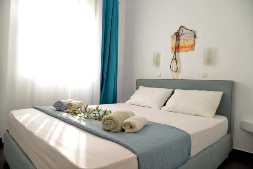 a bedroom with a bed with towels on it at Doliva Studio with private pool in Agios Gordios