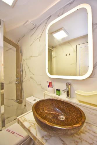 a bathroom with a sink and a mirror at Doliva Studio with private pool in Agios Gordios