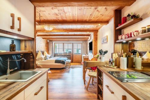 a kitchen with a sink and a living room at Chalet Bergliebe mit Zirbenholz in Inzell