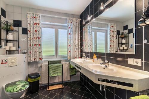 a bathroom with a sink and a mirror at Haus Ursula in Ettenheim