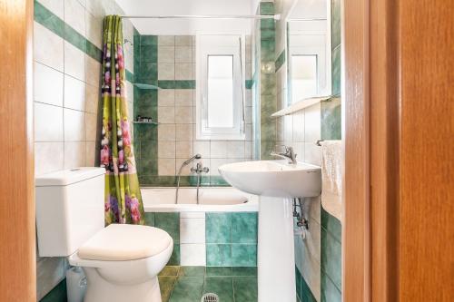 a bathroom with a toilet and a sink at White Pearl in Lachania