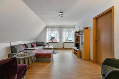 a living room with a couch and a tv at Ferienwohnung Weise in Schafstedt