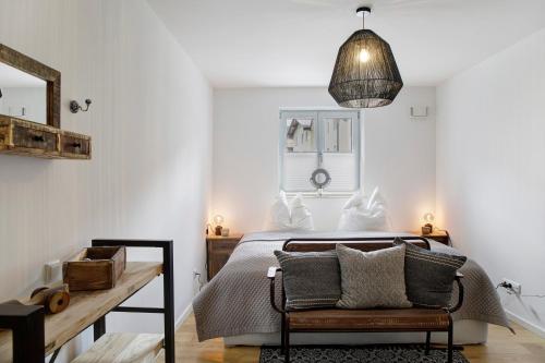 a bedroom with a bed with a chair and a table at Lieblingsplatz Ferienwohnung in Bad Tölz