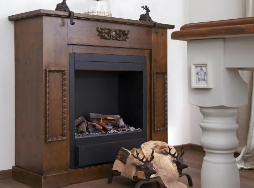a fireplace in a living room with a fire place at Kuckucks in Ibach