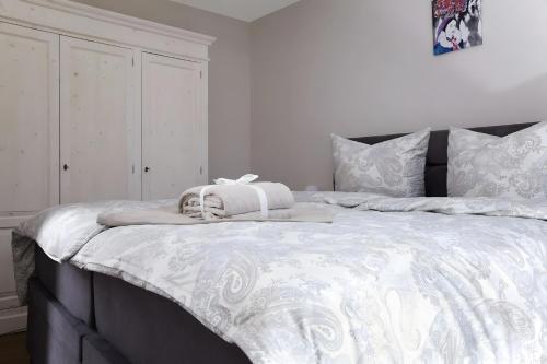 a bedroom with a large bed with a white comforter at Kuckucks in Ibach