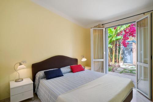 a bedroom with a bed and a sliding glass door at Villa Pairola - in San Bartolomeo al Mare
