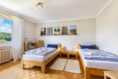 two beds in a room with a window at Ferienwohnung Lammerberg in Albstadt