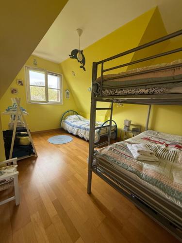 a bedroom with two bunk beds and a mirror at Les Buissons in Saint-Pierre-le-Vieux