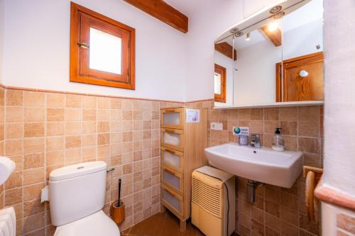 a bathroom with a toilet and a sink at Sa Torreta Luxury Views 3 Bedrooms in Sóller