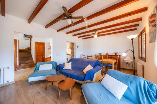 a living room with blue couches and a table at Sa Torreta Luxury Views 3 Bedrooms in Sóller