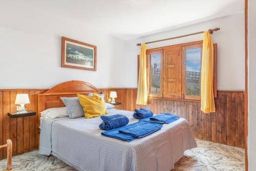 a bedroom with a bed with blue towels on it at Andres House, Tías in Tías
