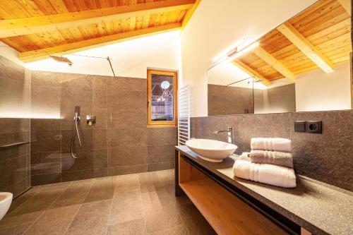 a bathroom with a sink and a shower at Huetterhof Apartement Herbischt in Caines