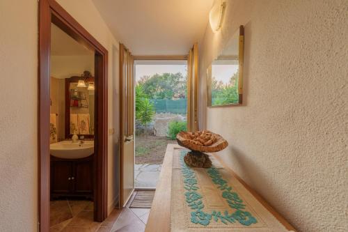 a bathroom with a sink and a bowl on a rug at Casa vacanza Macciunitta in Arzachena