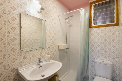 a bathroom with a sink and a toilet and a shower at El Campanar in Sant Llorenç de Morunys