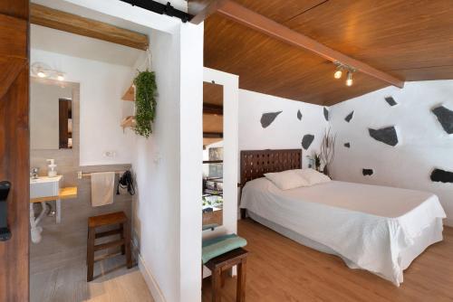 a bedroom with a bed and a bathroom at Casa Tajaraste 2 in Hermigua