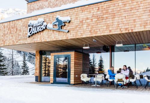 people sitting at a table outside of a restaurant at Lizum 1600 | Kompetenzzentrum Snowsport Tirol in Axamer Lizum