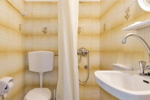 a bathroom with a toilet and a sink at Hotel Galini in Kalymnos