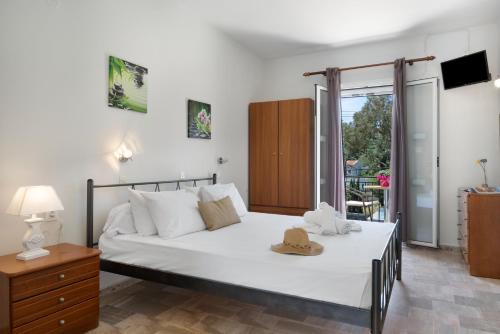 a bedroom with a bed with a hat on it at Ilias Voula Studios in Kalymnos