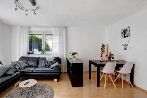 a living room with a couch and a table at Ferienwohnung am Hof in Zwiefalten