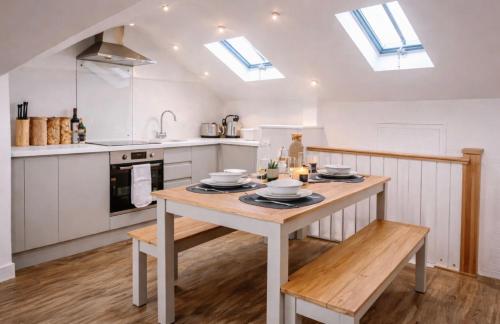 a kitchen with a wooden table in a room at Duplex Apartment - Central Harrogate Apartment in Harrogate