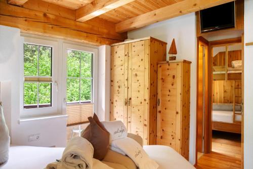 a room with wooden walls and a room with a couch at Ferienhaus Plattner in Oetz