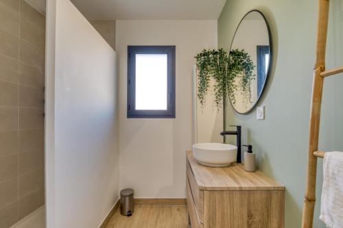 a bathroom with a sink and a mirror at Villa Mézoise in Mèze