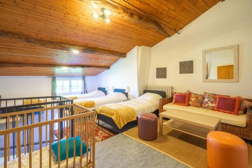 a living room with two beds and a balcony at Les gîtes du logis in Saint-Romain-de-Benet