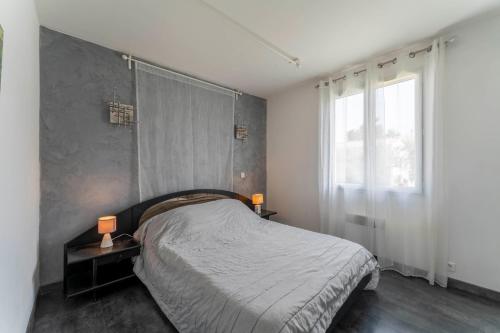 a bedroom with a bed and a large window at Chalet en Provence in Sorgues